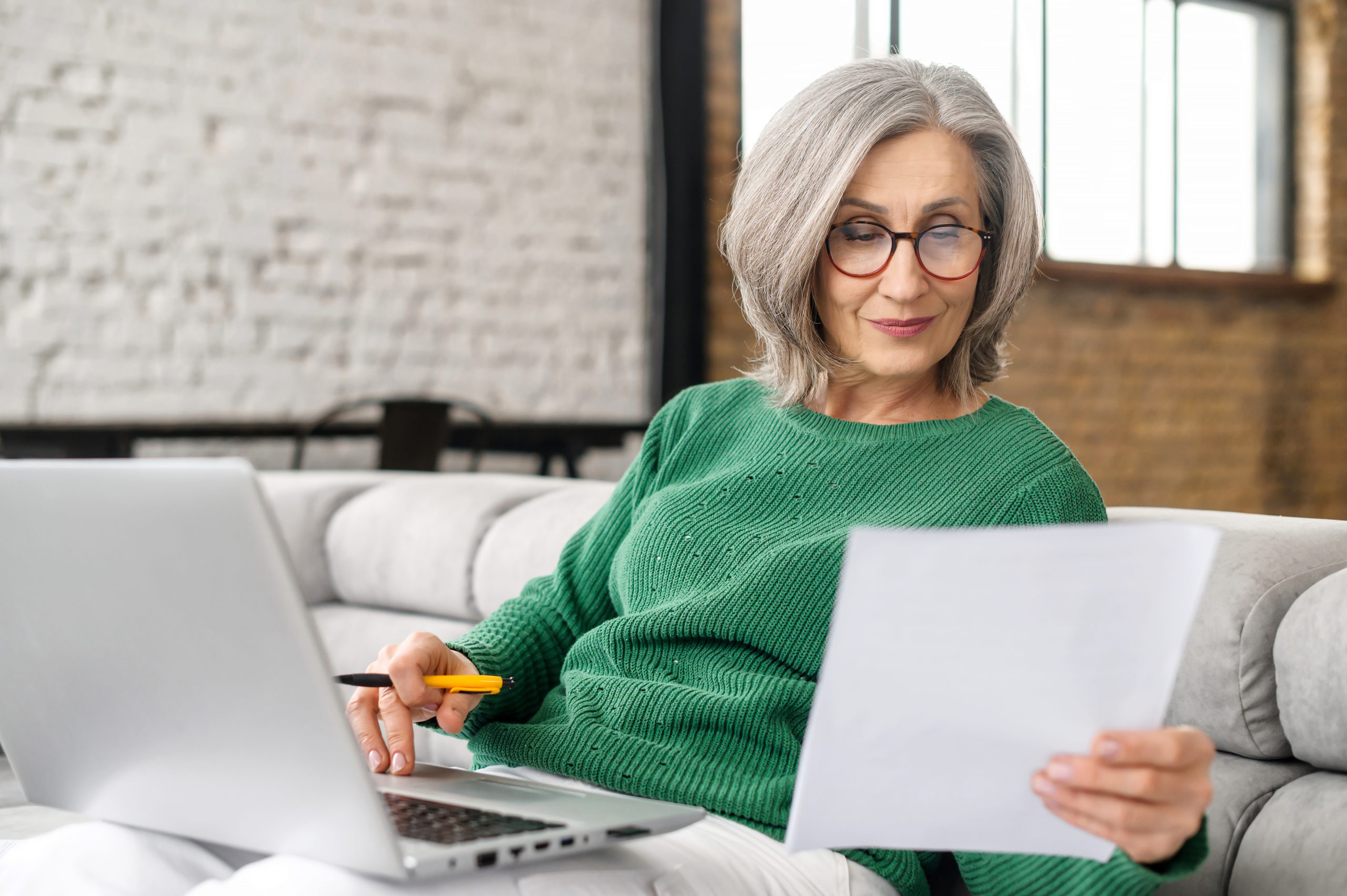 Mature senior woman using a laptop at home