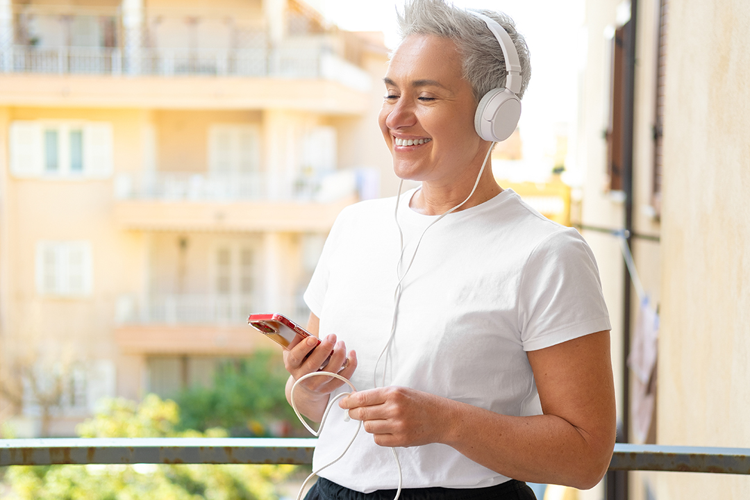 woman listening to audiobook and smiling