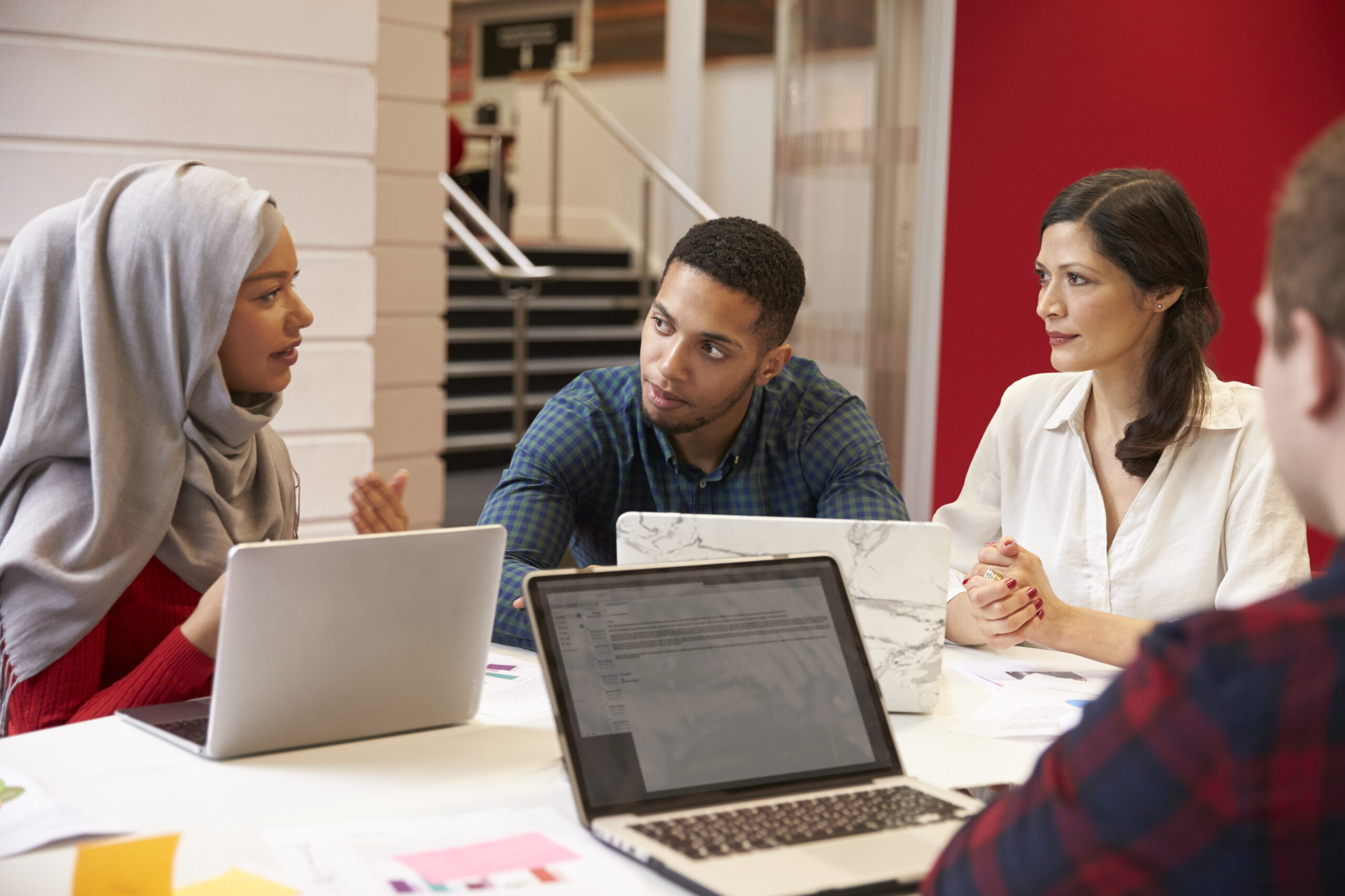 Group Of Students Meeting For Tutorial With Teacher