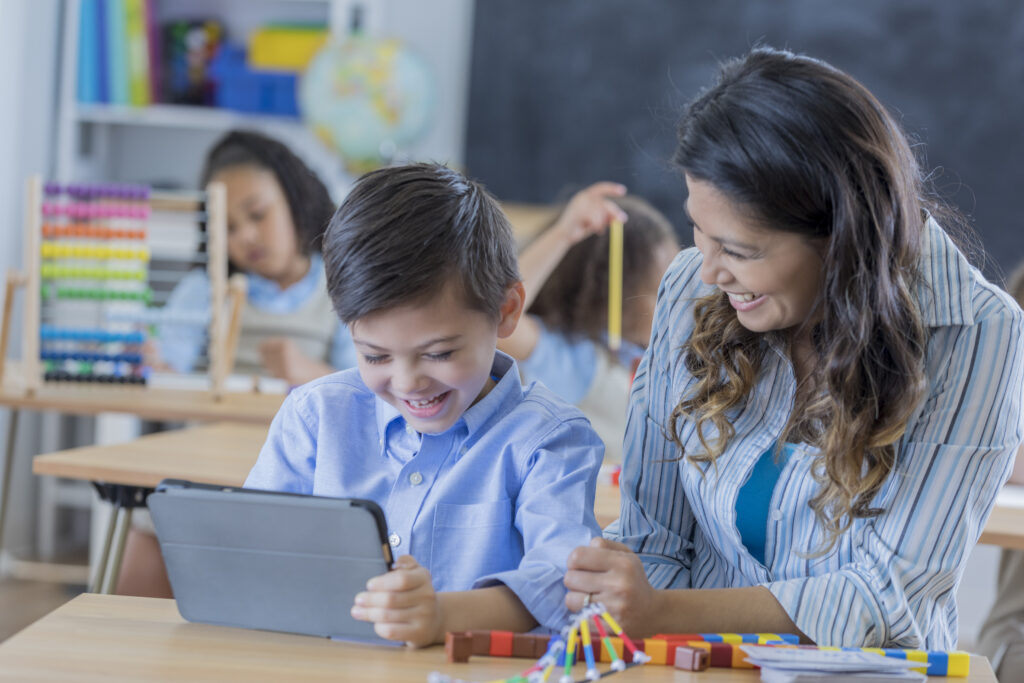 Teacher and student using a tablet to learn